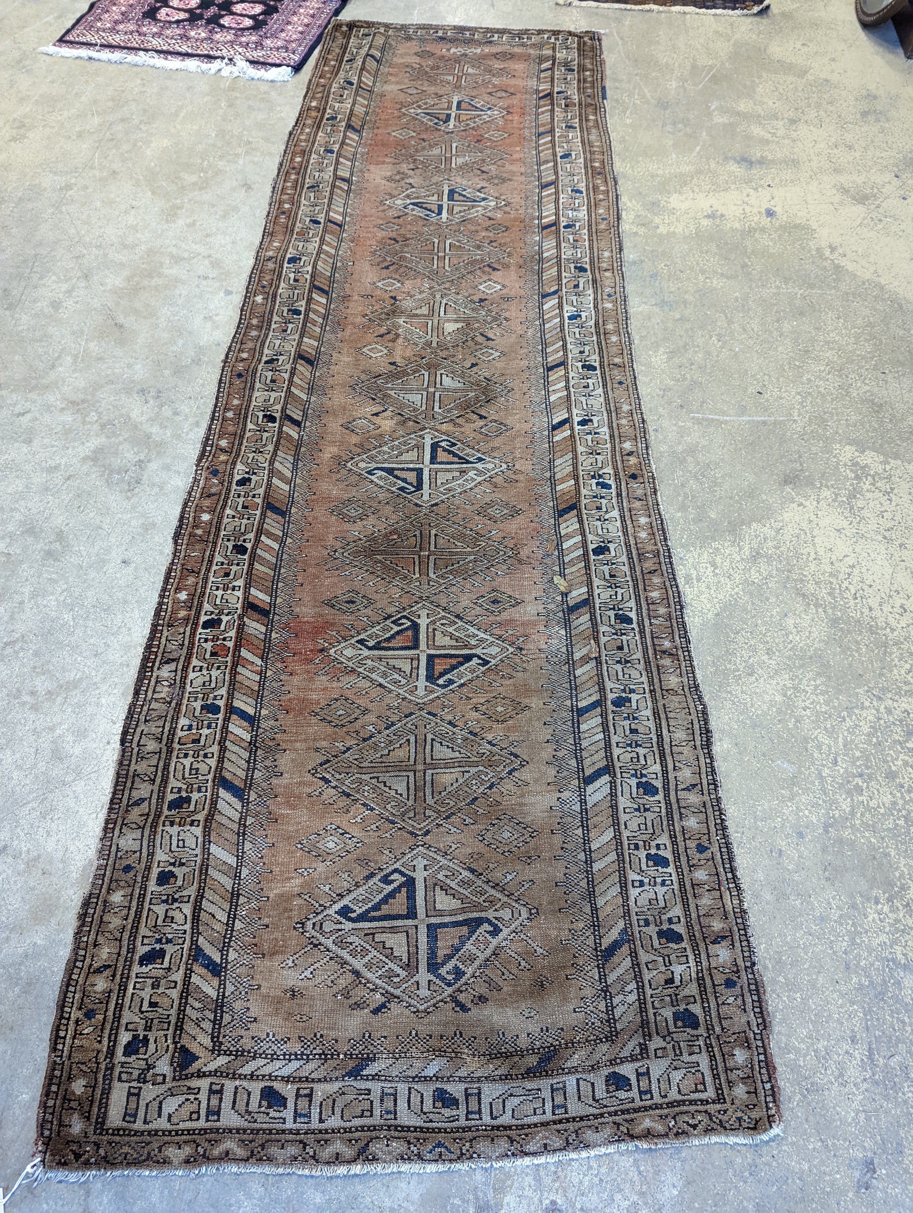 An antique Caucasian red ground runner, 372 x 106cm